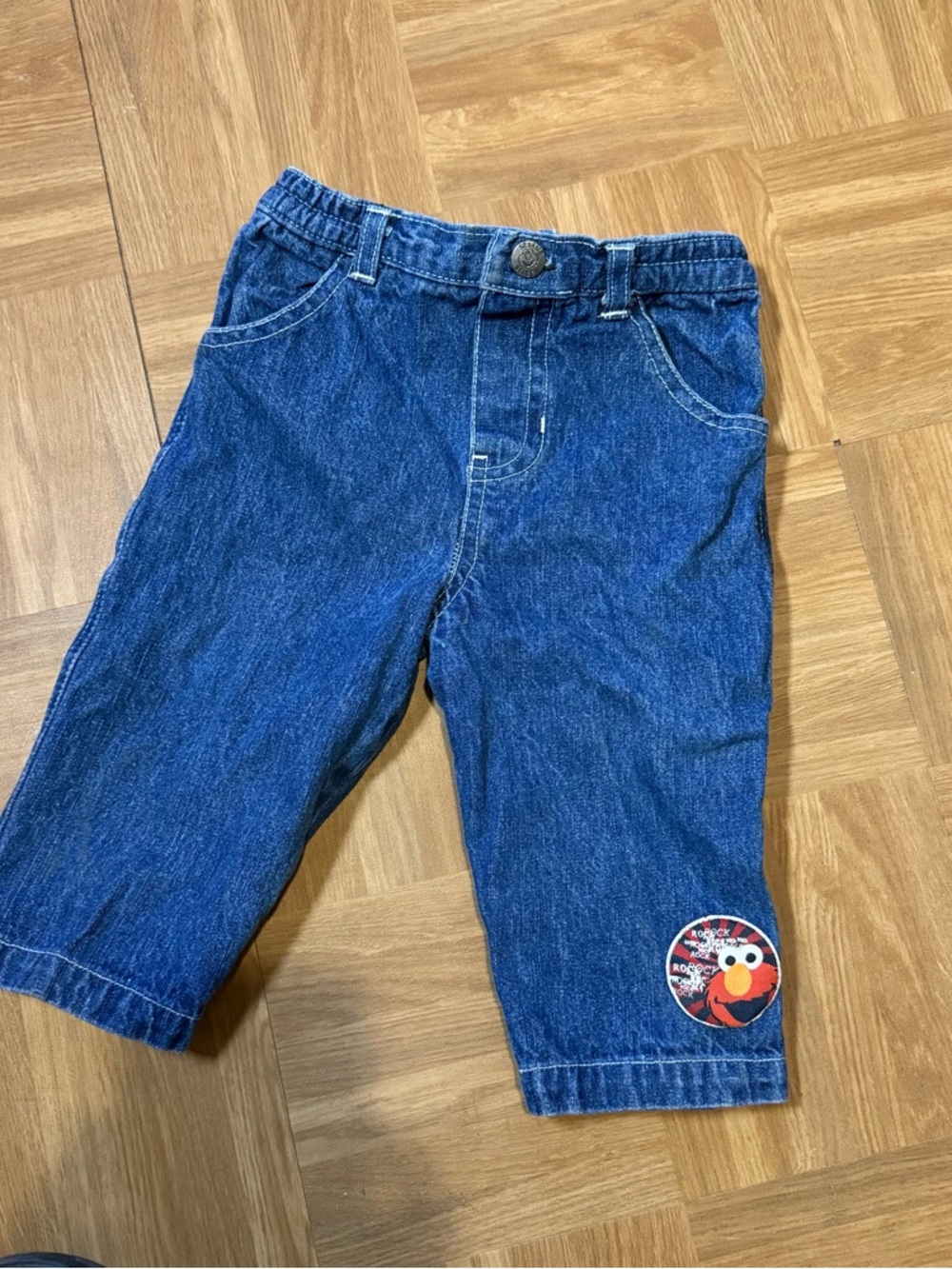 Sesame Street brand toddler blue denim jeans featuring an embroidered Elmo patch